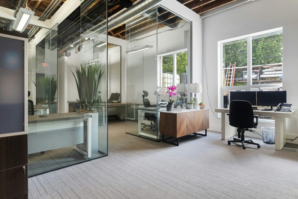 a room with a desk and chairs