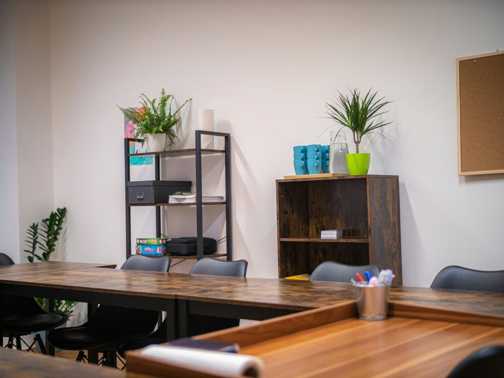 a room with a wooden table and black chairs