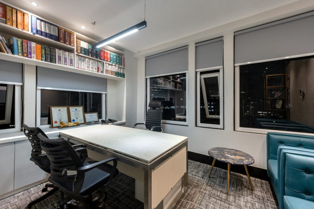 a room with a desk and shelves